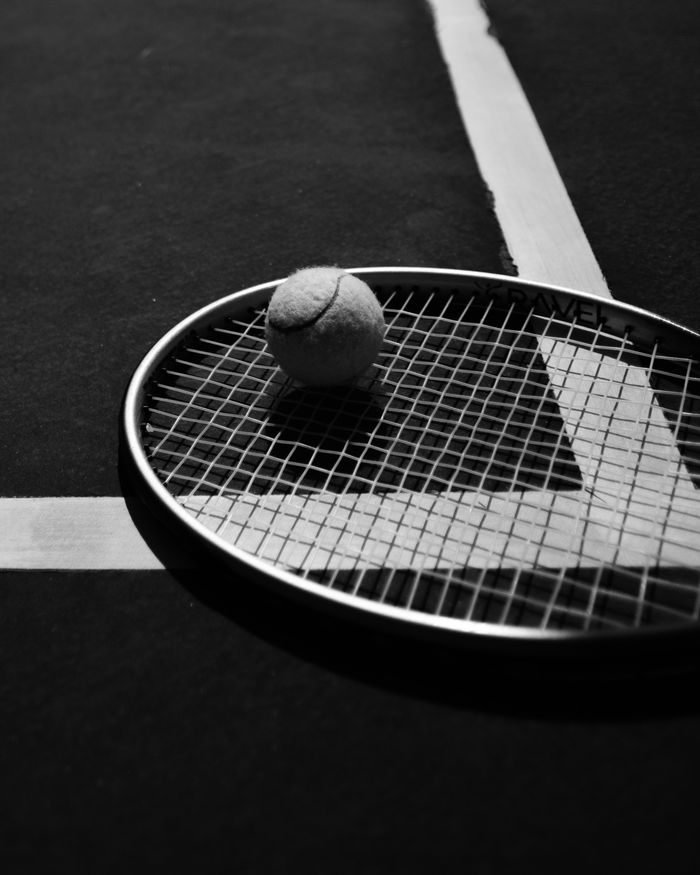 services-01 A close-up of a tennis racket and ball on a court in İzmir, Türkiye.